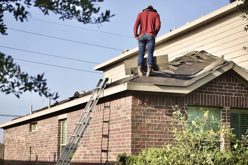 Professional roofer working on a residential roof in St. Andrews Place